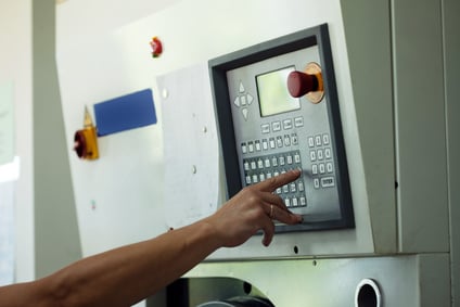 Man presses button on electronic control panel