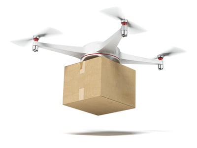 White quadrocopter carrying carton box
